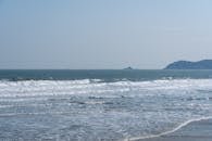 Peaceful ocean scene featuring gentle waves under a clear blue sky, ideal for relaxation concepts.